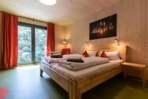 a bedroom with two beds and a large window at Hotel 11 Eulen in Uelzen