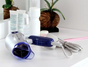 a hair dryer sitting on top of a counter with products at Melaka Downtown Guesthouse Apartment in Melaka