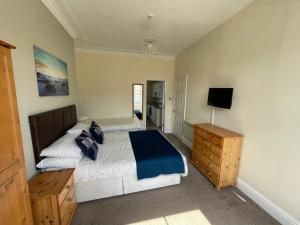 A bed or beds in a room at 45 The Square Holiday Apartments 