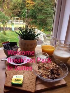 a table with a breakfast plate of food and orange juice at Commodore Guesthouse, Self-Catering Suites in Rothesay