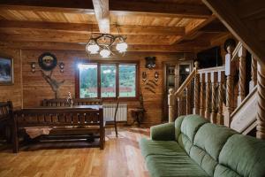 a living room with a couch and a table at Kyivska Russ Resort Medical&Spa in Skhidnitsa