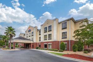 a large building with a large clock on the side of it at Comfort Inn & Suites Statesboro - University Area in Statesboro