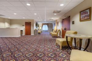 a lobby with chairs and tables and a waiting room at Comfort Inn & Suites Statesboro - University Area in Statesboro