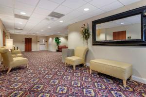 a waiting room with chairs and a mirror on the wall at Comfort Inn & Suites Statesboro - University Area in Statesboro