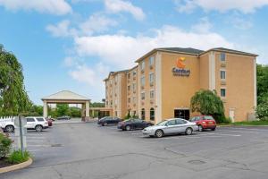 a hotel with cars parked in a parking lot at Comfort Inn & Suites Wilkes Barre - Arena in Wilkes-Barre