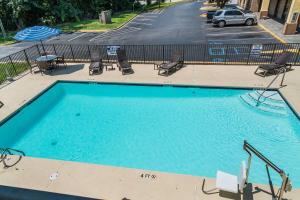 a large swimming pool with chairs and a parking lot at Quality Inn in Greer