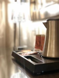 a coffee pot sitting on top of a counter at The Annexe - by Gloria Hotel in Jerusalem