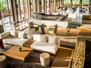 a lobby with couches and tables and chairs at New World Phu Quoc Resort in Phu Quoc