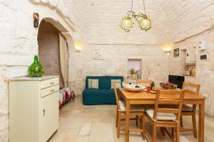 a kitchen and dining room with a table and chairs at Lovely Stone House In Ostuni in Ostuni