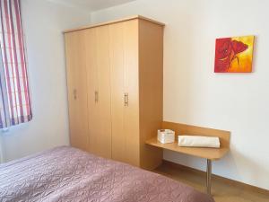 ビンツにあるFerienwohnung Schmachter Seeのベッドルーム1室(ベッド1台付)、キャビネットが備わります。