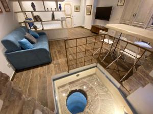 an overhead view of a living room with a blue couch at Camere Capobove Assisi in Assisi