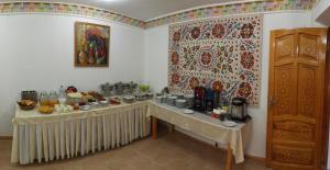 a room with a table with food on it at Emir in Bukhara