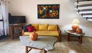 a living room with a couch and a painting on the wall at Cabarete Beachfront Condos at Nanny Estate C-5 in Cabarete