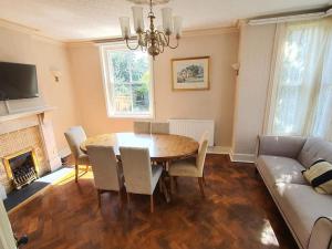 a living room with a table and a couch at Spectacular Period Property Located In Leicester in Leicester