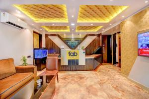 a lobby with a couch and a tv in a building at FabHotel S Comfort Inn in Bangalore