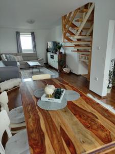 a living room with a wooden floor and a staircase at Apartman Glacier in Tatranska Strba