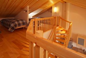 a wooden staircase in a room with a bedroom at Polar Star Origo Apartments in Levi