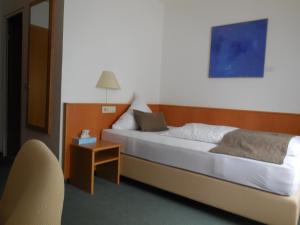 Postel nebo postele na pokoji v ubytování Hotel Schober