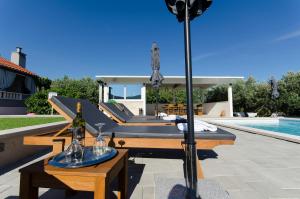 a patio with a table with two bottles of wine at Villa Bepo in Plano +31 photos