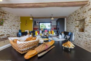 a dining room with a table with bread on it at La Lisière du Morvan in Magny-Lormes