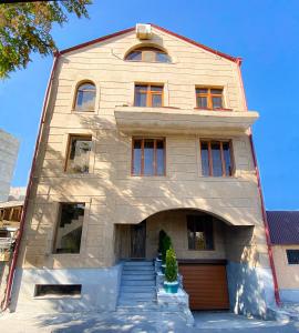 a large house with a staircase in front of it at Shirbakyan Boutique Hotel & Apartments in Yerevan