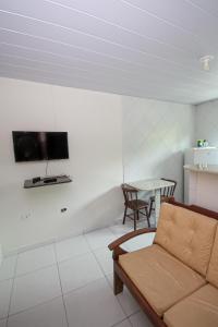 a living room with a couch and a table at Pousada Santa Fé in Porto De Galinhas +53 photos