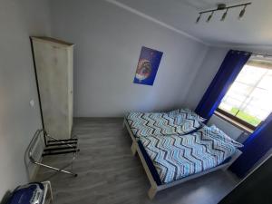 a small bedroom with a bed and a window at Na Starówce 1 in Żywiec