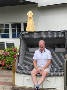a man is sitting in a play structure at Ferienhaus Thönnes in Norderney