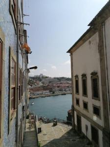 a view of a river from between two buildings at Douro View House Ribeira in Porto
