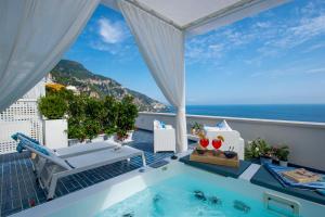a balcony with a plunge pool and a view of the ocean at Terrazza Zaffiro in Positano