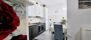 a kitchen with white cabinets and a table in it at GUEST HOLIDAY LIEBIG in Reggio Emilia