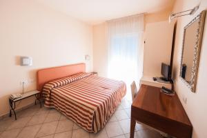 Postel nebo postele na pokoji v ubytování Alba Hotel