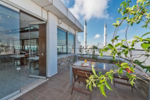 a balcony with a wooden table and a view of the mosque at Dab Hotel in Istanbul