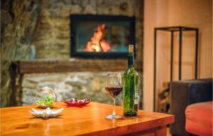 a bottle of wine and a glass on a table at Lovely Apartment In La Omauela With Kitchen in La Omañuela