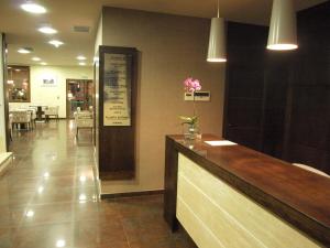 a restaurant with a counter with a vase of flowers on it at Dinastia in Getafe