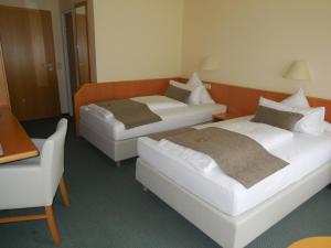 Postel nebo postele na pokoji v ubytování Hotel Schober