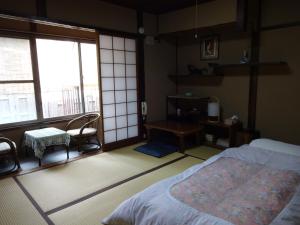 Postel nebo postele na pokoji v ubytování Ryokan Uemura
