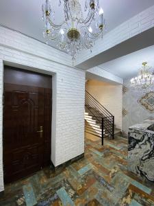 a large room with a door and a chandelier at Shirbakyan Boutique Hotel & Apartments in Yerevan