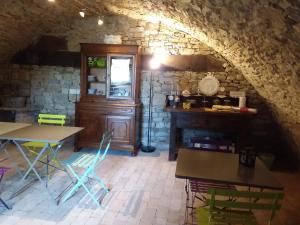 a kitchen with a table and chairs in a room at Monpoupon in Gropparello