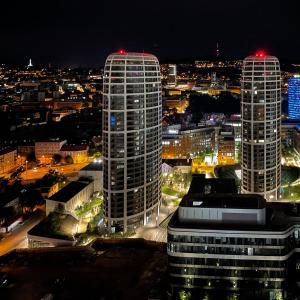 two tall buildings in a city at night at Downtown View in Bratislava