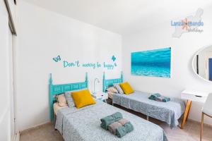 Łóżko lub łóżka w pokoju w obiekcie Vivienda Vacacional Timanfaya