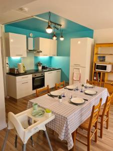 a kitchen and dining room with a table and chairs at La Mongie Yes ! in Bagnères-de-Bigorre