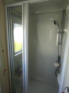 a shower with a glass door in a bathroom at Mamacecilas in Morecambe