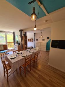 a dining room with a table and chairs at La Mongie Yes ! in Bagnères-de-Bigorre