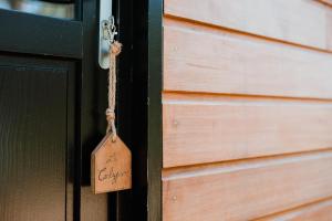a wooden door with a tag on it at Tiny Stay - Ecolodge in Clefs-Val d'Anjou