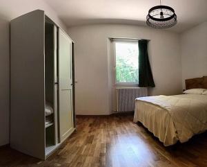 a bedroom with a bed and a dresser and a window at CASA DELLE GUARDIE b&b in Madonna di Fornelli