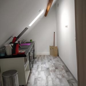 a kitchen with white walls and a floor with a counter at La Vannerie in Béthisy-Saint-Martin +16 photos
