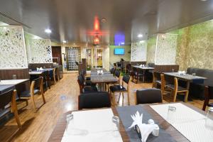 a restaurant with tables and chairs in a room at Aygro Hotel in Dubai