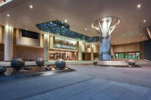a building with a fountain in the middle of it at Crowne Plaza Guangzhou City Centre by IHG - Free shuttle between hotel and Exhibition Center during Canton Fair & Exhibitor registration Counter in Guangzhou