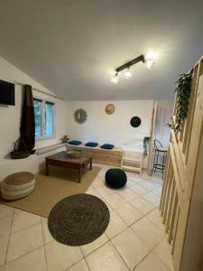 a living room with a couch and a table at L’Escapade. Entre Aix et Marseille, studio pleine nature. in Fuveau